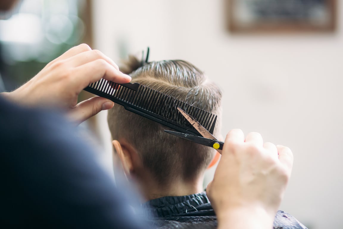 Little Boy Getting Haircut by Barber 